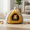 A cozy plush hanging nest shaped like a leaf, featuring gray and yellow fabric, used for small pets.