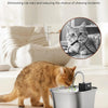 A tabby cat is drinking water from a stainless steel cat water fountain with a smart sensor.