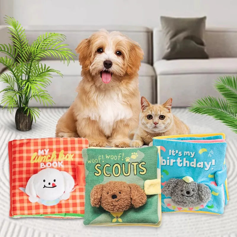 A golden retriever puppy is sitting next to a small orange fabric book toy for dogs.