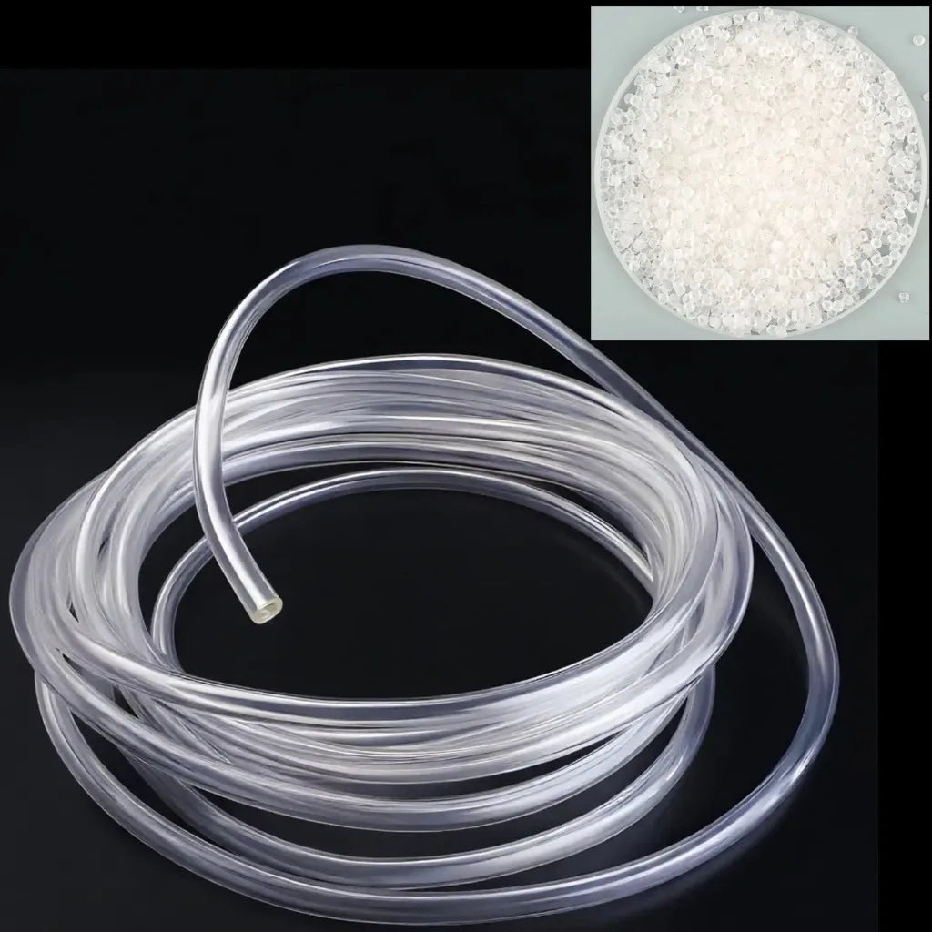 A coil of clear PVC flexible tubing is shown next to a petri dish containing white granular material.