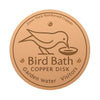 Bain à oiseaux rond en cuivre avec la silhouette d'un oiseau, conçu pour l'eau de jardin.