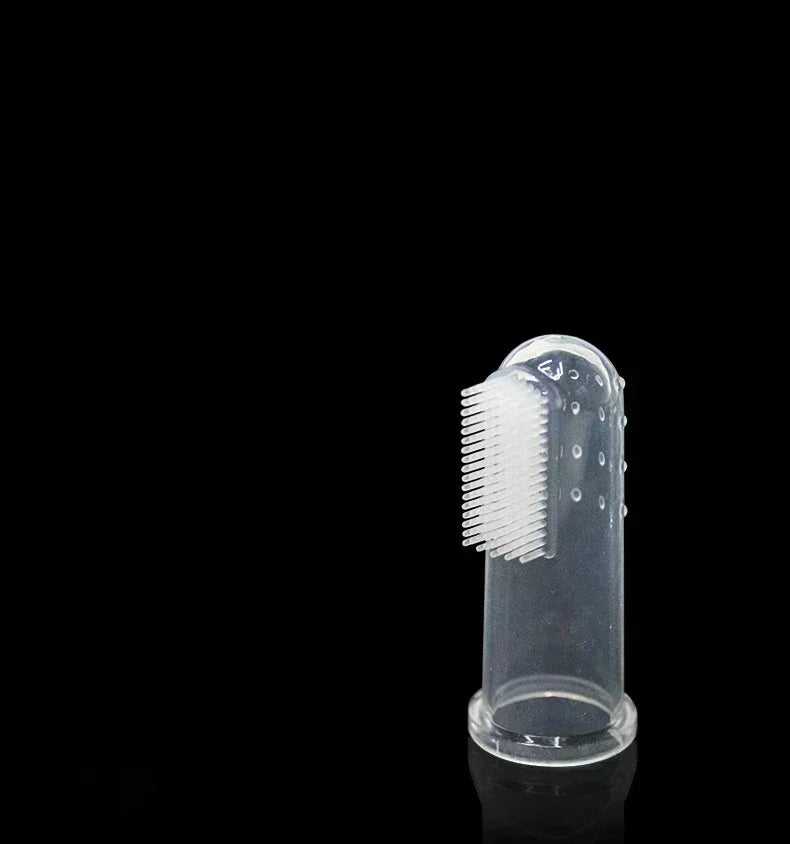 A clear silicone finger toothbrush for dogs with bristles, shown against a black background.