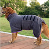 A brown dog wearing a gray quick-dry microfiber robe outdoors on a wooden deck.