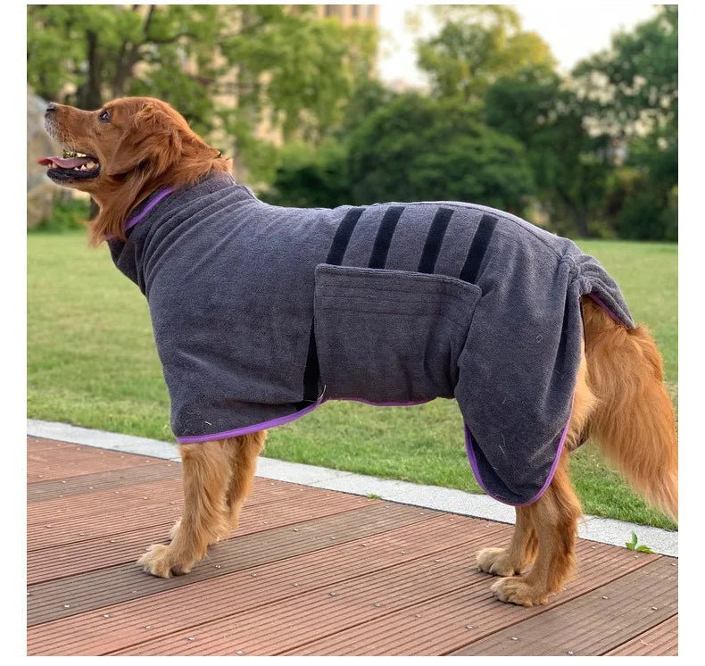 A brown dog wearing a gray quick-dry microfiber robe outdoors on a wooden deck.