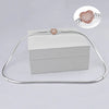 A sterling silver snake chain necklace with a heart charm displayed on a white box.