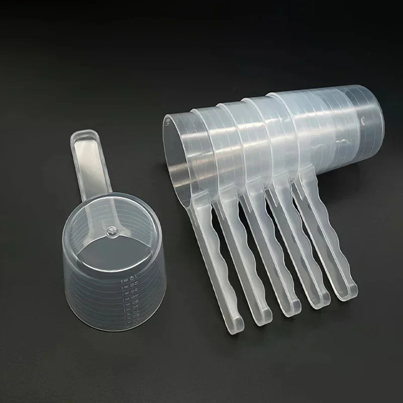 A transparent pet measuring spoon with a scale for dog and cat food, shown in a plastic dispenser format.