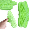 A bright green silicone pet licking mat with suction cups is shown being held by a hand.