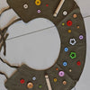 A round, olive green fabric product with various colored buttons and a wooden stick, likely for pet grooming.
