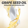 A close-up of grape seed oil dripping onto a white fabric, illustrating its softening and moisturizing properties.
