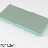 A rectangular cleaning brush with a light green body and a pale blue trim.