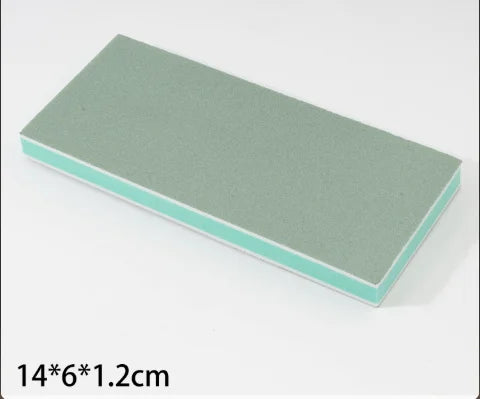 A rectangular cleaning brush with a light green body and a pale blue trim.