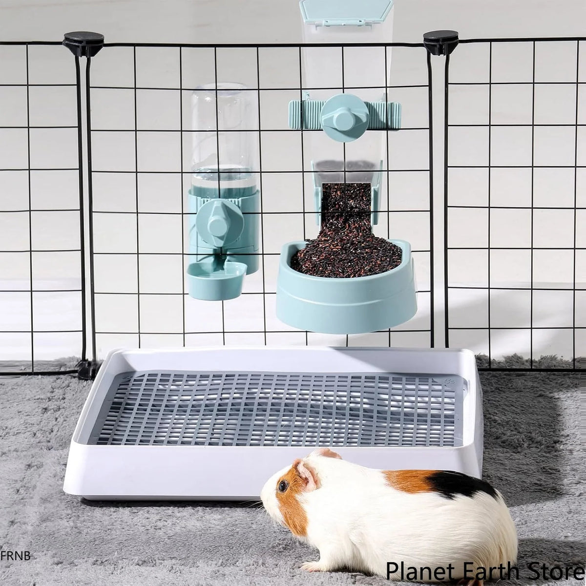A pet warming mat is shown with a small white and brown animal resting on it, positioned in front of a wire enclosure.