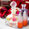 Glass dropper bottles containing pink and orange liquid extracts on a white surface