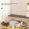 A gray cat is relaxing in a woven, round scratching post designed for cat claws and furniture protection.