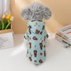 A fluffy grey dog-shaped raincoat with brown bear designs on a light blue background.