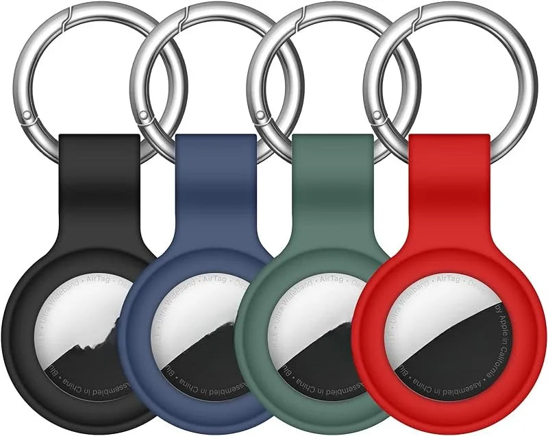 A silicone AirTag protective cover is shown attached to a metal keychain ring in various colors.
