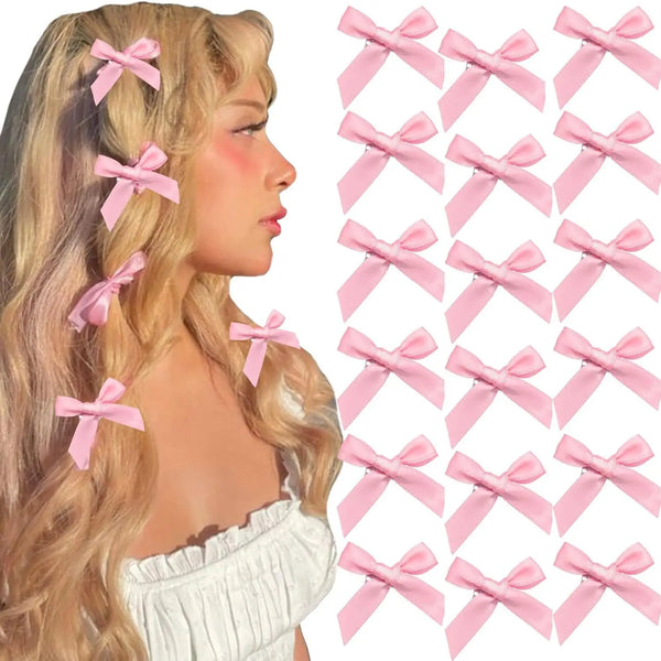 A set of pink ribbon bow hair clips worn in blonde wavy hair.