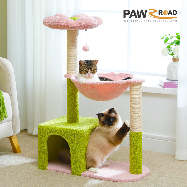 A pink and green flower cat tree with a sisal hammock is shown, featuring a cat resting on the structure.