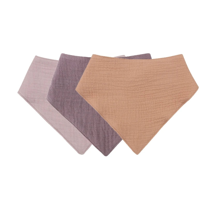 A pack of three soft cotton baby bibs in shades of pink, gray, and beige.
