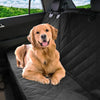 A golden retriever dog lying on a black waterproof car seat cover in the back seat of a vehicle.