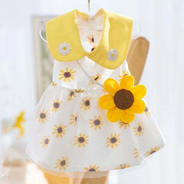 A yellow and white mesh dress for dogs with a floral collar and skirt.