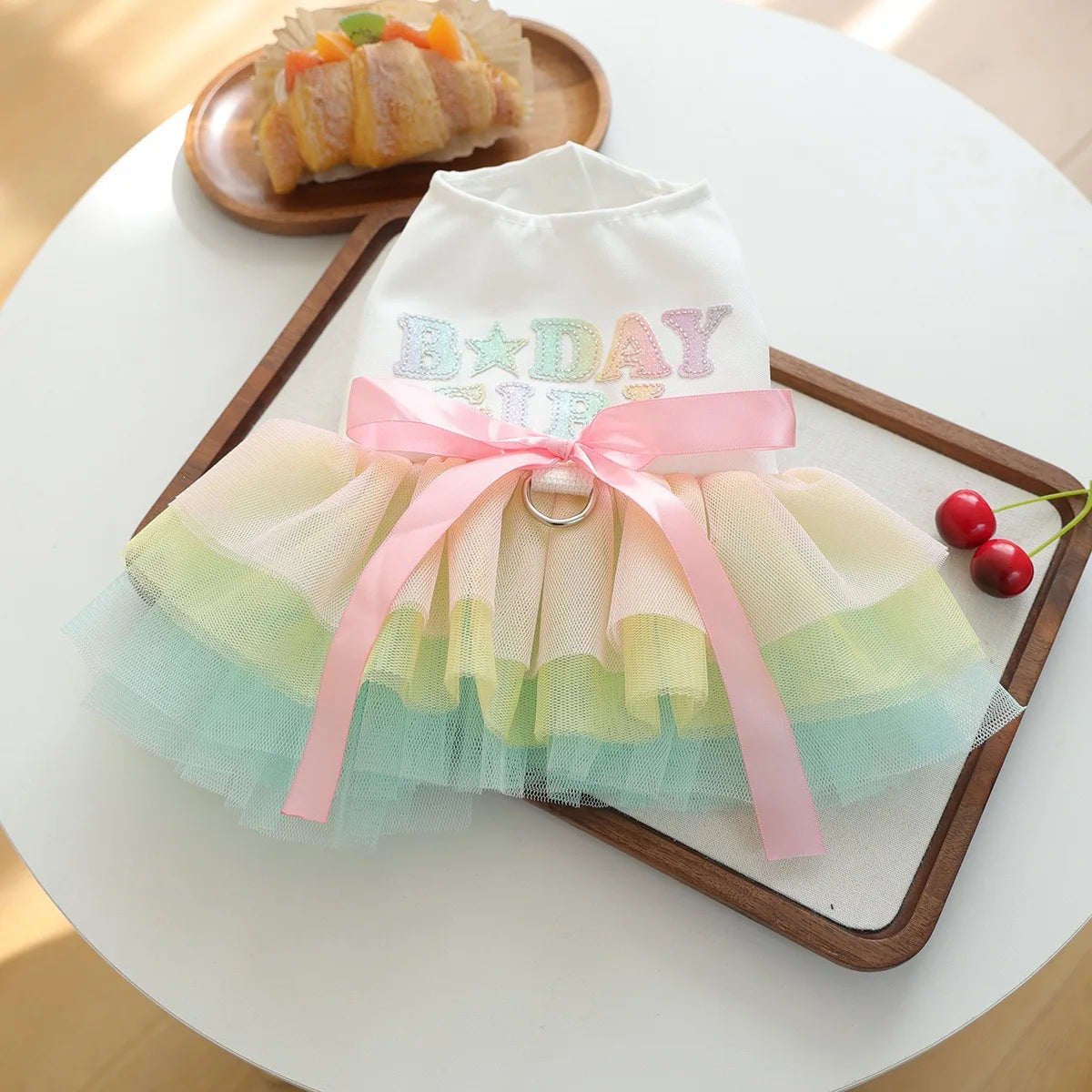 Elegant birthday suit for dogs featuring a white tulle top with pink ribbon details.