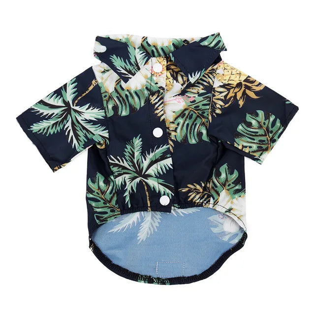 A dark blue shirt with a tropical leaf print featuring green and yellow foliage.