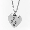 A silver stainless steel heart-shaped necklace featuring four paw prints engraved on the pendant.