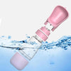 A pink 2-in-1 portable pet water and food dispenser bottle submerged in clear blue water.