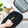 A hand is wearing a black electrostatic hair removal glove designed for pets.