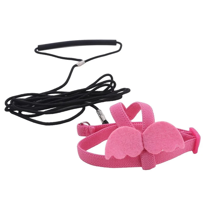 Pink parrot bird harness and leash set with a black strap and pink fabric
