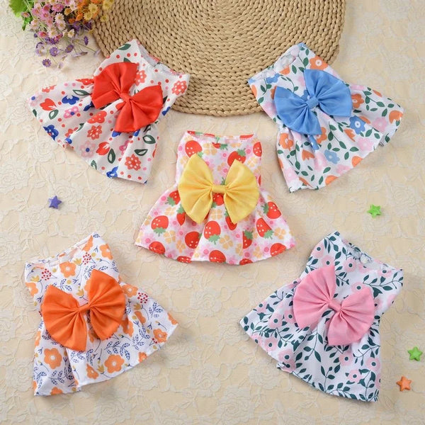 A collection of floral patterned fabric bows and fabric pieces in various colors like orange pink blue and yellow