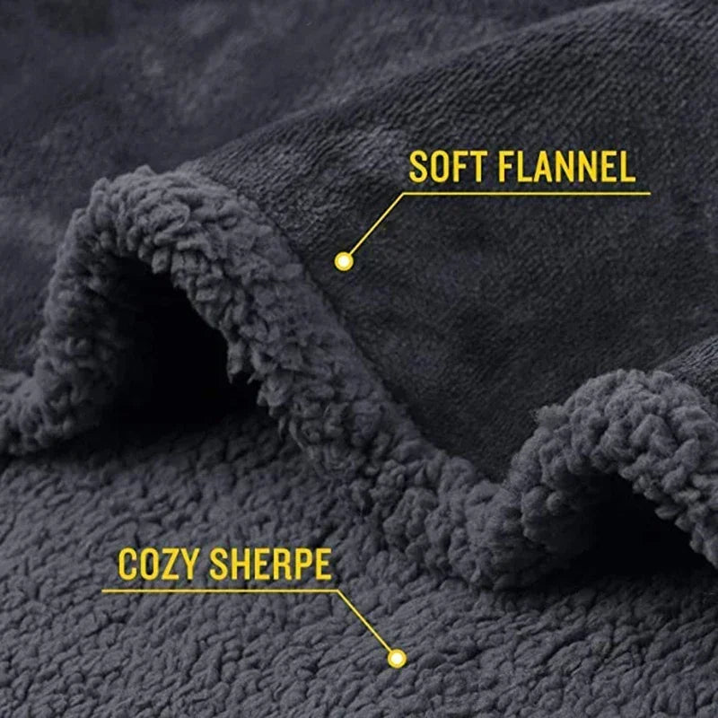 Close-up of a dark gray soft flannel fabric with cozy sherpa trim and labeling.