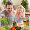 A child is interacting with a 3D printed floating betta hammock for aquarium decor in a glass tank.