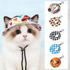 A fluffy white and brown cat wearing an orange patterned pet bucket hat