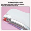 Close-up view of a white V-shaped tight comb with red teeth used for pet hair removal.