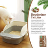 A white cat is interacting with a litter box containing a natural deodorizer cat litter product.