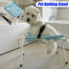 A white dog is resting on a light blue pet bathing stand for grooming.