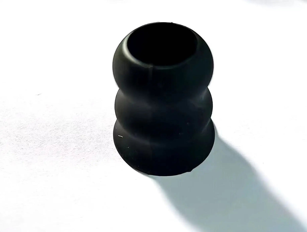 Black silicone bat grip knobs used to secure or modify baseball bats.