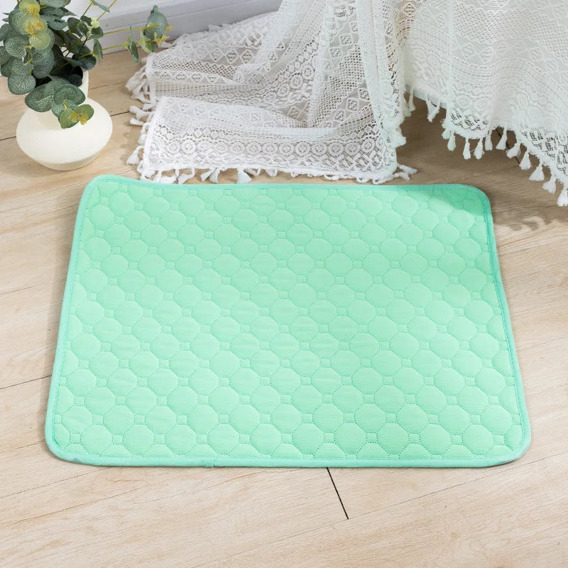 A light green hexagonal pet training mat placed on a wooden floor next to lace fabric.