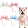 A set of pink and white handmade dog hair bows for a small white dog.