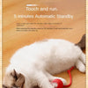 A white and gray cat is interacting with a red ball toy designed for automatic standby.