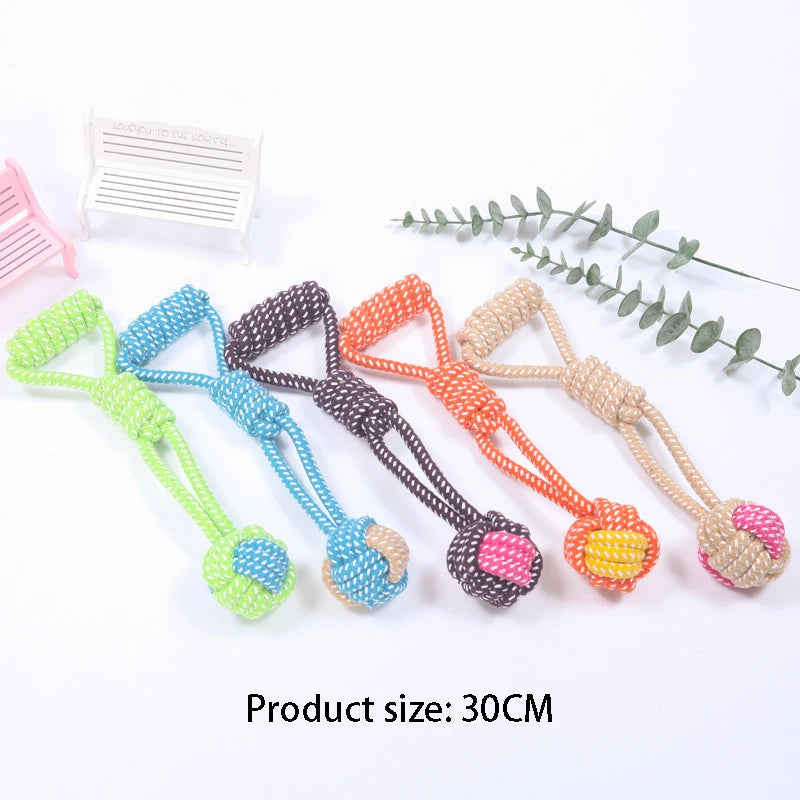 A collection of colorful cotton rope dog chew toys with various knots and textures displayed on a white background.