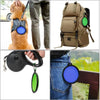 A portable silicone pet feeder bowl with a carabiner is shown being used by a dog and attached to clothing.