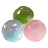 Drei durchscheinende, klebrige Stressball-Bälle in Grüntönen, Blau und Pink.