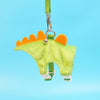 A bright lime green cartoon animal vest harness with orange accents hanging from a green strap.