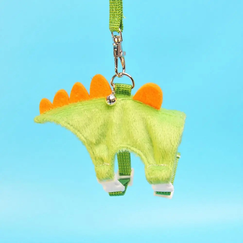A bright lime green cartoon animal vest harness with orange accents hanging from a green strap.