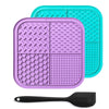 A purple silicone lick mat for pets is shown next to a black silicone spoon.