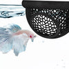 A betta fish swims near a black mesh hammock designed for aquarium decoration.