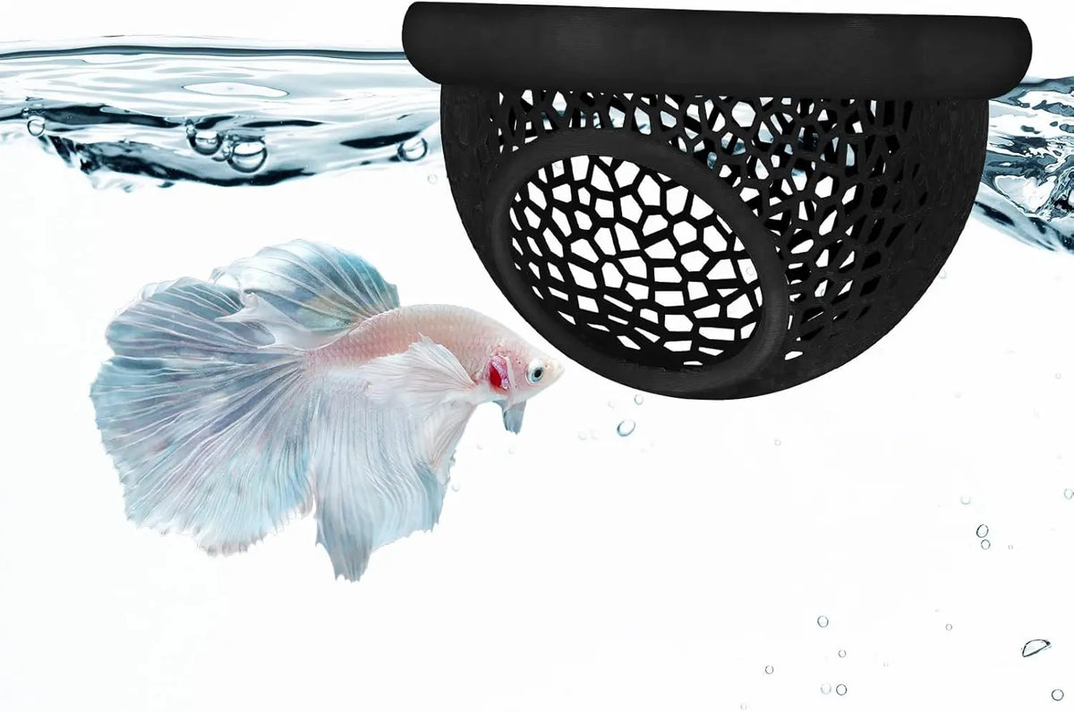 A betta fish swims near a black mesh hammock designed for aquarium decoration.
